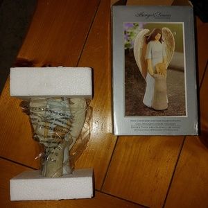 Girl hugging Angel figurine